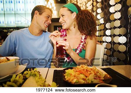 Hawaii, Oahu, Couple Feeding Each Other At A Trendy Restaurant. View Large Photo Image Picture - Hawaii, Oahu, Couple Feeding Each Other At A Trendy Restaurant.. Fotosearch
