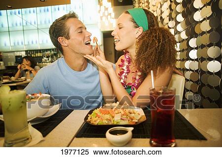 Hawaii, Oahu, Couple Feeding Each Other At A Trendy Restaurant. View Large Photo Image Stock Photography - Hawaii, Oahu, Couple Feeding Each Other At A Trendy Restaurant.. Fotosearch