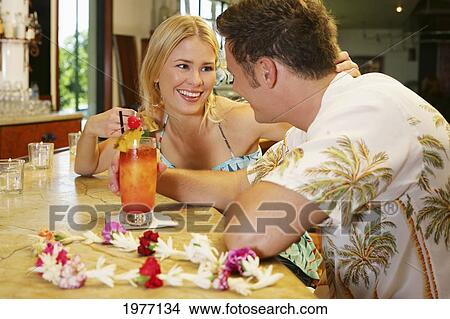 Picture - Hawaii, Oahu, Couple Having Drinks At A Bar.. Fotosearch