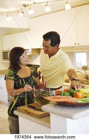Picture - Hawaii, Oahu, Couple Preparing A Healthy Salad In A Kitchen.. Fotosearch
