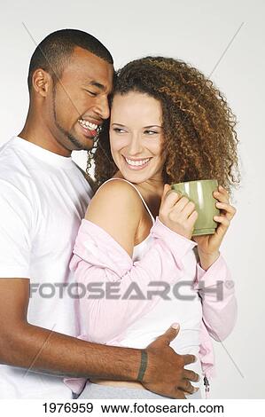 Stock Photo - Hawaii, Oahu, Couple With Coffee Cup.. Fotosearch