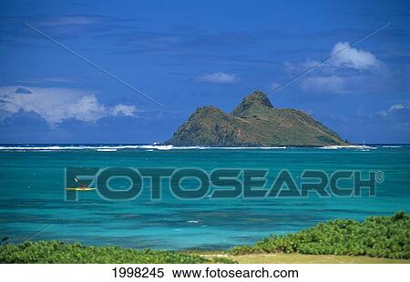 Stock Photography - Hawaii, Oahu, Distant View Of Kayaker Along Windward Coast, Mokulua In Background. Fotosearch
