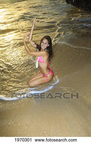 Stock Image - Hawaii, Oahu, Eternity Beach, Beautiful Woman Modeling On The Shore. Fotosearch
