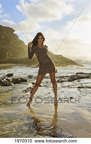 Stock Image - Hawaii, Oahu, Eternity Beach, Beautiful Woman Modeling At Sunrise. Fotosearch