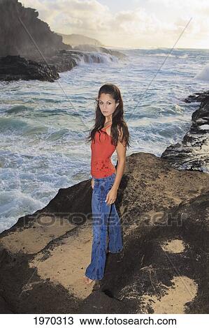 Stock Image - Hawaii, Oahu, Eternity Beach, Beautiful Woman Stands By The Shore. Fotosearch
