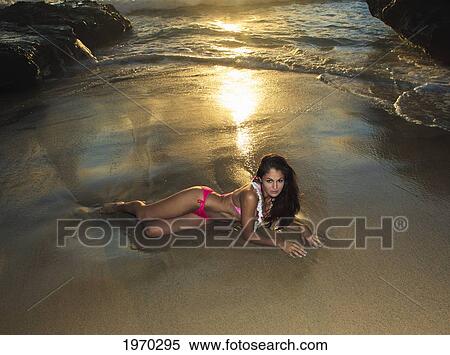 Stock Photography - Hawaii, Oahu, Eternity Beach, Beautiful Woman Modeling On The Shore. Fotosearch