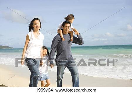 Picture - Hawaii, Oahu, Family Walking On The Beach.. Fotosearch