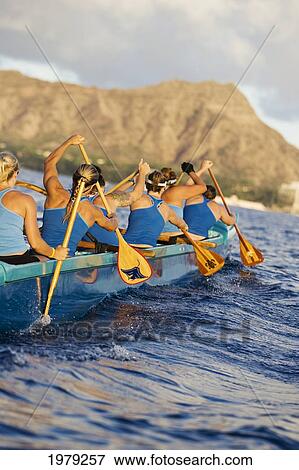 Stock Photo - Hawaii, Oahu, Female Outrigger Canoe Team Paddling Towards Diamond Head.. Fotosearch