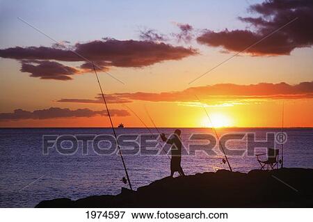 Hawaii, Oahu, Fisherman Holding His Fishing Line In The Sunset. View Large Photo Image Stock Photo - Hawaii, Oahu, Fisherman Holding His Fishing Line In The Sunset.. Fotosearch
