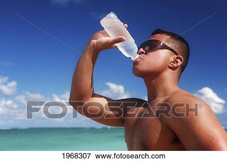 Hawaii, Oahu, Fit Male Drinking Water At The Beach. View Large Photo Image Stock Photo - Hawaii, Oahu, Fit Male Drinking Water At The Beach.. Fotosearch