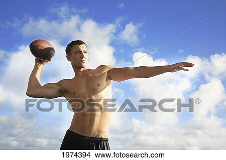 Picture - Hawaii, Oahu, Fit Male Holding A Football At The Tidepool.. Fotosearch