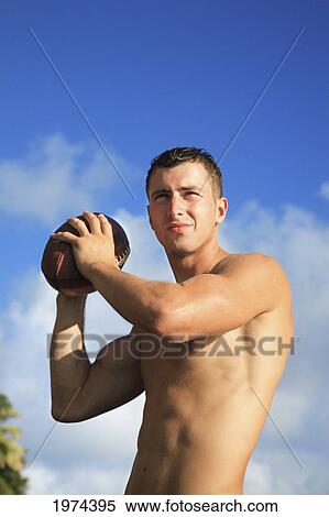 Hawaii, Oahu, Fit Male Holding A Football At The Tidepool. View Large Photo Image Stock Photography - Hawaii, Oahu, Fit Male Holding A Football At The Tidepool.. Fotosearch