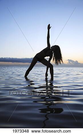 Stock Photo - Hawaii, Oahu, Fit Young Girl On The Beach Doing Yoga On The Coastline.. Fotosearch