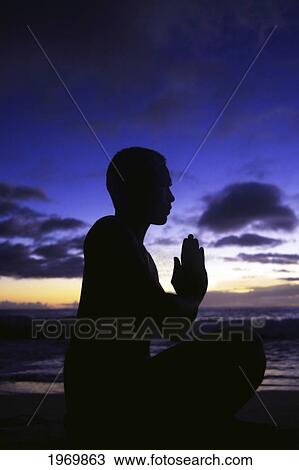 Stock Image - Hawaii, Oahu, Fit Young Guy On The Beach Doing Yoga On The Coastline.. Fotosearch