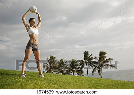 Hawaii, Oahu, Fit Young Woman Holding A Volleyball. View Large Photo Image Stock Photo - Hawaii, Oahu, Fit Young Woman Holding A Volleyball.. Fotosearch