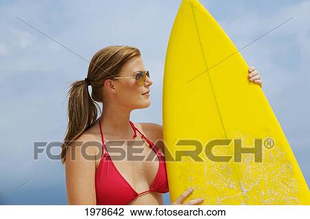 Stock Image - Hawaii, Oahu, Girl On Beach With Yellow Surfboard.. Fotosearch