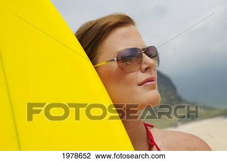 Stock Image - Hawaii, Oahu, Girl On Beach With Yellow Surfboard.. Fotosearch