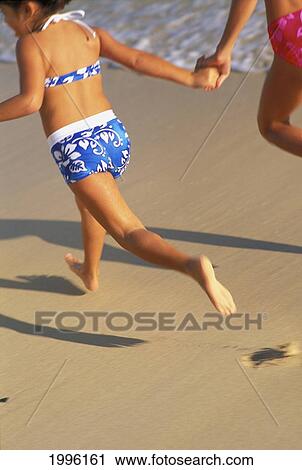 Hawaii, Oahu, Girls Running On Lanikai Beach Holding Hands View From Behind On Shore View Large Photo Image Stock Image - Hawaii, Oahu, Girls Running On Lanikai Beach Holding Hands View From Behind On Shore. Fotosearch