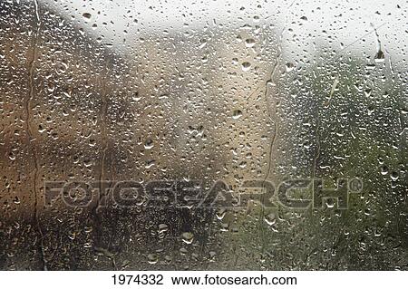 Stock Image - Hawaii, Oahu, Glass Window With Raindrops.. Fotosearch