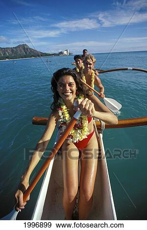 Stock Photo - Hawaii, Oahu, Group Of Paddlers In An Outrigger Canoe, Diamond Head In Background. Fotosearch