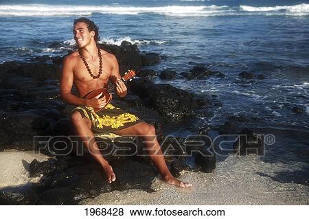 Stock Photo - Hawaii, Oahu, Hawaii, Oahu, Local Young Man Playing Ukulele On The Rocks At The Beach.. Fotosearch
