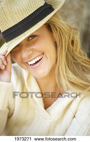 Stock Image - Hawaii, Oahu, Headshot Of A Beautiful Woman Wearing A Hat.. Fotosearch