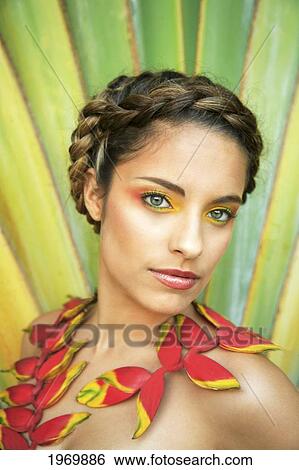 Stock Photograph - Hawaii, Oahu, Headshot Of Attractive Beautiful Female With Braided Hair And Heliconia Flowers Around Her Neck.. Fotosearch