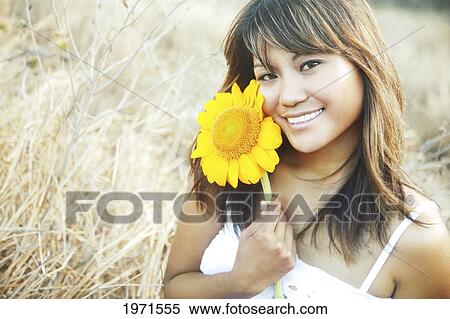 Hawaii, Oahu, Headshot Of Beautiful Asian Woman With Sunflower. View Large Photo Image Stock Photography - Hawaii, Oahu, Headshot Of Beautiful Asian Woman With Sunflower.. Fotosearch