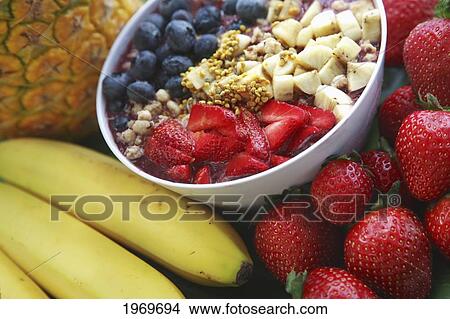 Picture - Hawaii, Oahu, Healthy And Organic Berry Acai Bowl Next To Assorted Fruits.. Fotosearch