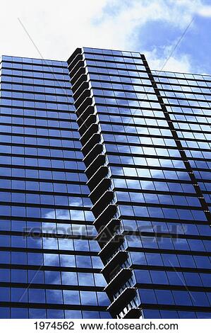 Stock Image - Hawaii, Oahu, Honolulu, Downtown Financial District Of A Tower With The Blue Sky Reflecting On Windows.. Fotosearch