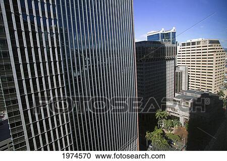Stock Image - Hawaii, Oahu, Honolulu, Downtown Financial District Of A Tower With The Blue Sky Reflecting On Windows.. Fotosearch