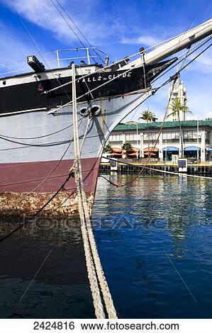 Hawaii, Oahu, Honolulu Harbor, Falls of Clyde ship with Aloha Tower in the background. View Large Photo Image Stock Photograph - Hawaii, Oahu, Honolulu Harbor, Falls of Clyde ship with Aloha Tower in the background.. Fotosearch
