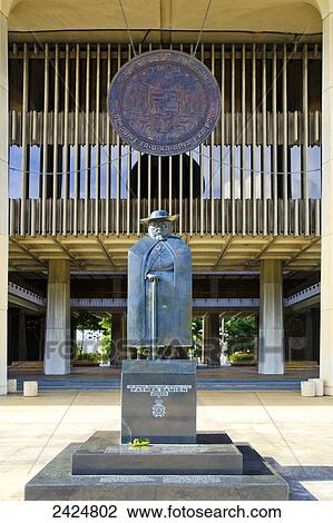 Stock Image - Hawaii, Oahu, Honolulu, Hawaii State Capitol Building, statue of Father Damien.. Fotosearch