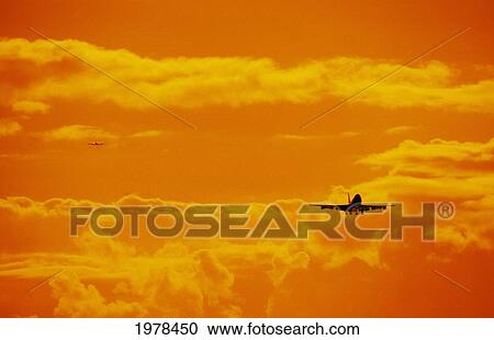 Stock Image - Hawaii, Oahu, Honolulu International Airport, Boeing 747 Jet Landing At Sunset.. Fotosearch