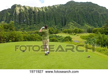 Stock Photo - Hawaii, Oahu, Honolulu, Ko'olau Golf Course, Man Driving On The 5Th Hole With Beautiful Mountain View.. Fotosearch