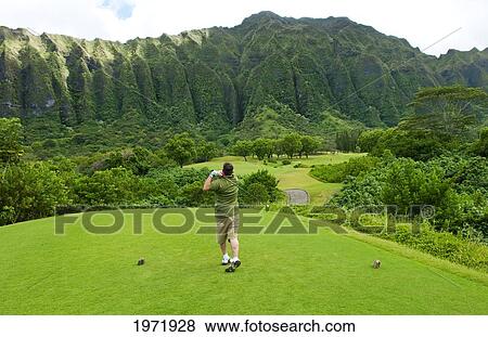 Stock Photo - Hawaii, Oahu, Honolulu, Ko'olau Golf Course, Man Drives At The Fifth Hole.. Fotosearch