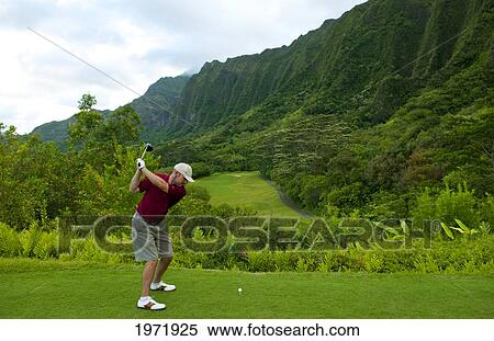 Stock Photography - Hawaii, Oahu, Honolulu, Ko'olau Golf Course, Man Driving On The 15Th Hole With Beautiful Mountain View.. Fotosearch