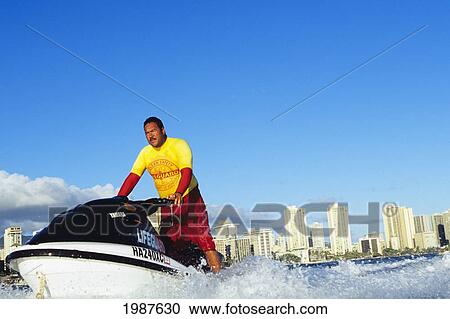 Hawaii, Oahu, Honolulu, Lifeguard Driving Rescue Jet Ski, View From Ocean. No Model Release View Large Photo Image Stock Image - Hawaii, Oahu, Honolulu, Lifeguard Driving Rescue Jet Ski, View From Ocean. No Model Release. Fotosearch