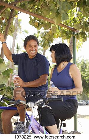 Stock Photography - Hawaii, Oahu, Honolulu, Local Couple Enjoying A Bike Ride Together.. Fotosearch
