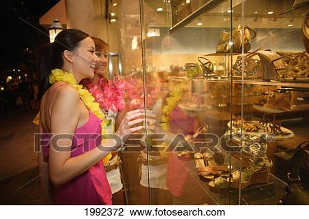 Hawaii, Oahu, Honolulu, Two Female Japanese Tourists Shopping In Waikiki At Night. View Large Photo Image Stock Image - Hawaii, Oahu, Honolulu, Two Female Japanese Tourists Shopping In Waikiki At Night.. Fotosearch