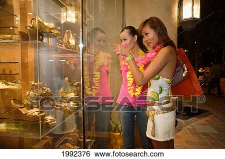 Hawaii, Oahu, Honolulu, Two Female Japanese Tourists Shopping In Waikiki At Night. View Large Photo Image Stock Photograph - Hawaii, Oahu, Honolulu, Two Female Japanese Tourists Shopping In Waikiki At Night.. Fotosearch