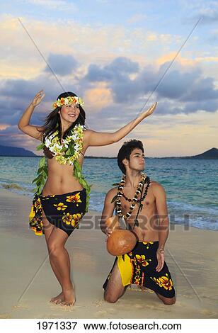 Hawaii, Oahu, Hula Dancer Couple Along Beach Shoreline At Sunrise. View Large Photo Image Stock Photo - Hawaii, Oahu, Hula Dancer Couple Along Beach Shoreline At Sunrise.. Fotosearch