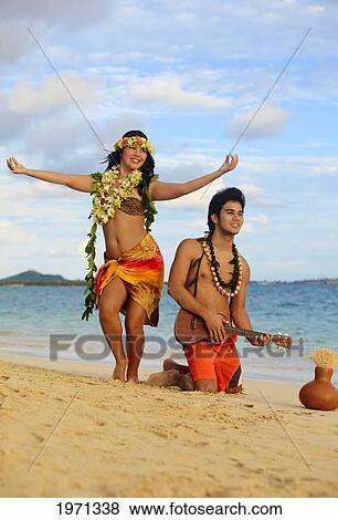 Hawaii, Oahu, Hula Dancer Couple Dancing Along Beach Shoreline. View Large Photo Image Stock Photo - Hawaii, Oahu, Hula Dancer Couple Dancing Along Beach Shoreline.. Fotosearch