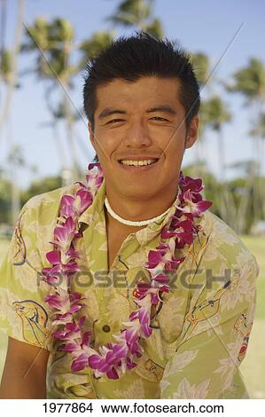 Picture - Hawaii, Oahu, Japanese Man Wearing Lei, Palm Trees In Background.. Fotosearch