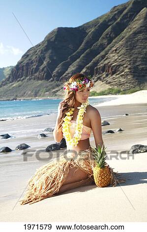 Stock Photo - Hawaii, Oahu, Kaena Point, Attractive Hula Girl Sitting On Beach.. Fotosearch