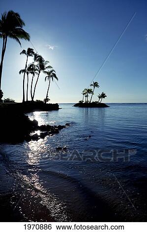 Stock Photograph - Hawaii, Oahu, Kahala Beach, Early Morning Light On The Water. Fotosearch