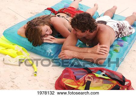 Hawaii, Oahu, Kailua Beach, Couple Lay On Inflatable Rafts On The Beach. View Large Photo Image Stock Image - Hawaii, Oahu, Kailua Beach, Couple Lay On Inflatable Rafts On The Beach.. Fotosearch