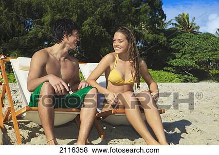 Hawaii, Oahu, Kailua, Lanikai, A young couple watching the surf with their boards. View Large Photo Image Stock Photo - Hawaii, Oahu, Kailua, Lanikai, A young couple watching the surf with their boards.. Fotosearch