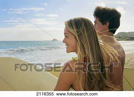 Hawaii, Oahu, Kailua, Lanikai, A young couple watching the surf with their boards. View Large Photo Image Stock Photography - Hawaii, Oahu, Kailua, Lanikai, A young couple watching the surf with their boards.. Fotosearch