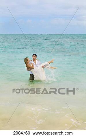Hawaii, Oahu, Kailua, Lanikai Beach, Newlywed Couple Emerging From Ocean After Taking A Dip In Wedding Attire. View Large Photo Image Stock Image - Hawaii, Oahu, Kailua, Lanikai Beach, Newlywed Couple Emerging From Ocean After Taking A Dip In Wedding Attire.. Fotosearch